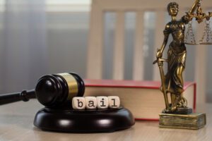 A gavel next to the scales of justice. Do you have to pay 100% of your bond?