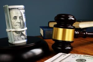 A roll of money next to a gavel. How does a property bond work?